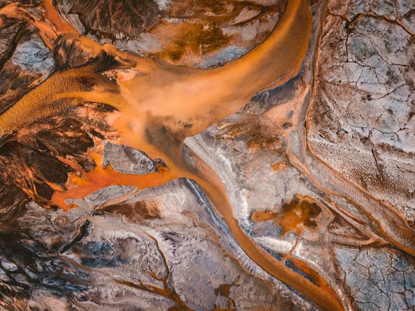 abstract photograph of mud spreading across cracked eart